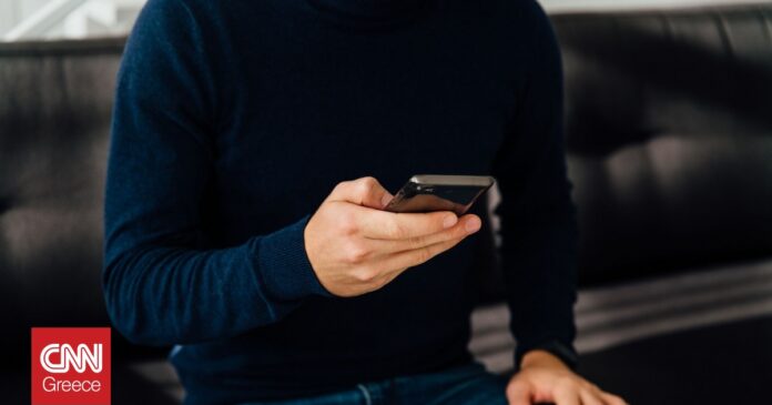 db40648f close up view male hand using mobile phone og.jpg