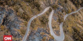 bf132e18 aerial shot curvy road mountains with trees og.jpg
