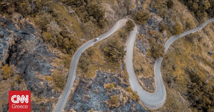 bf132e18 aerial shot curvy road mountains with trees og.jpg