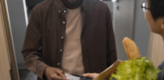 man paying groceries front view 618x412.jpg