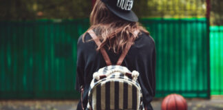 young girl sitting plastic orange penny shortboard asphalt cap 618x412.jpg