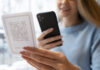 close up smiley woman scanning qr 618x412.jpg