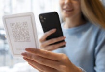 close up smiley woman scanning qr 618x412.jpg