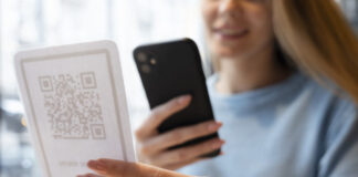 close up smiley woman scanning qr 618x412.jpg