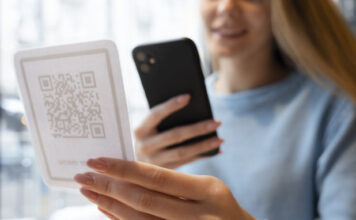 close up smiley woman scanning qr 618x412.jpg