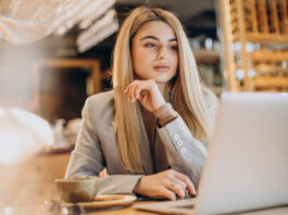 business woman sitting cafe working online 618x412.jpg