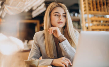 business woman sitting cafe working online 618x412.jpg