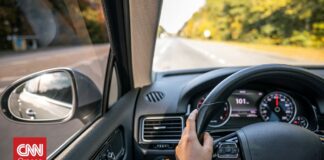 02b3bc4b woman drivers hands steering wheel inside car og.jpg