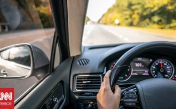 02b3bc4b woman drivers hands steering wheel inside car og.jpg